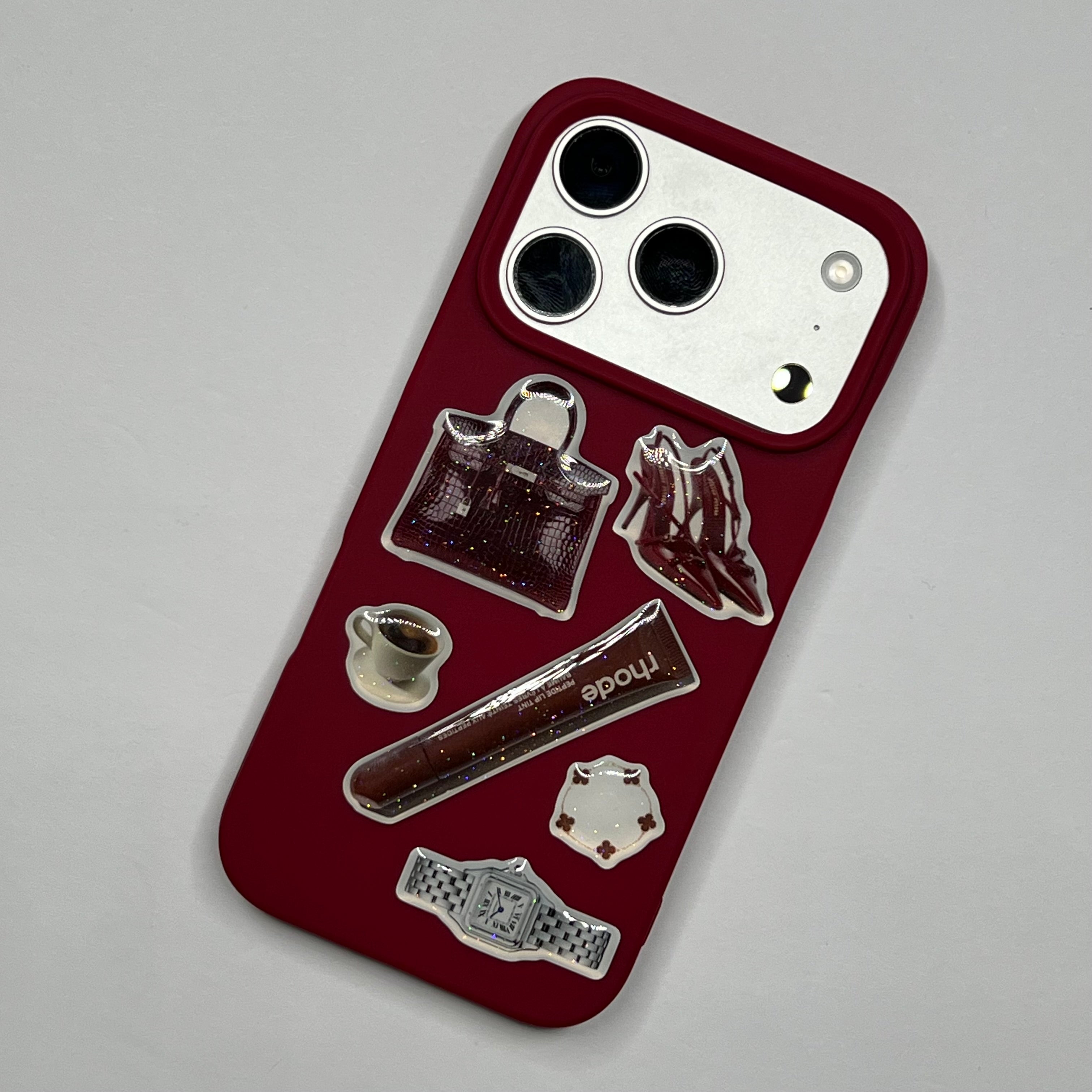 Phone case with decorative stickers on a gray background